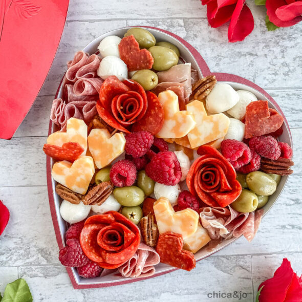 Valentine's Day charcuterie board in a heart-shaped candy box | Chica